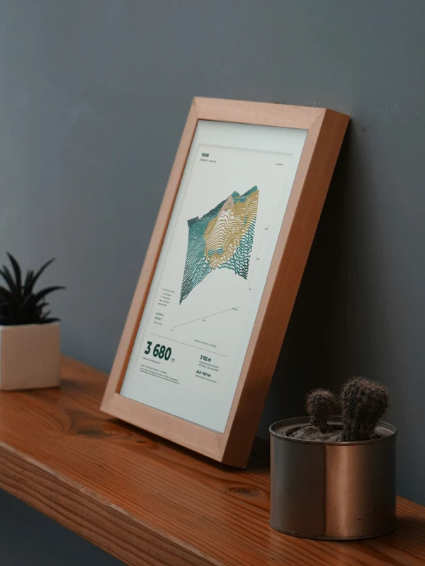 The Teide artwork digitally placed in a frame on a shelf beside plants. Framing and proportions are illustrative.